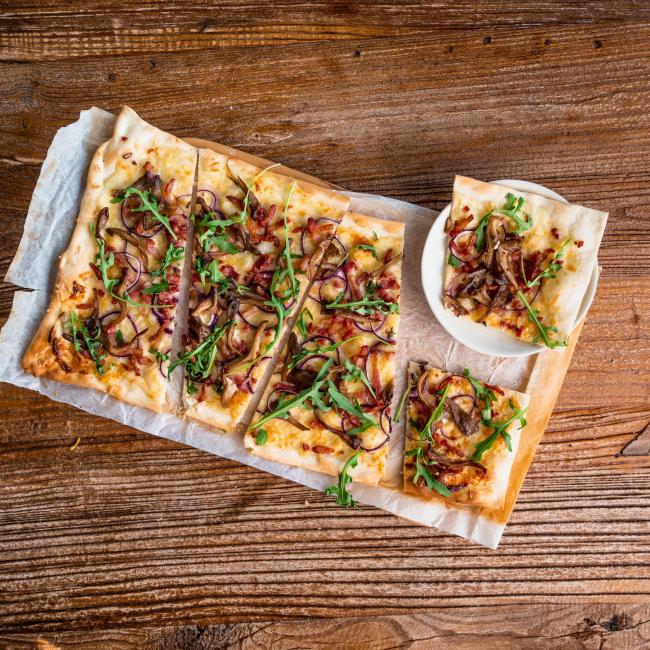 Flammkuchen with bacon, onion, and oyster mushrooms